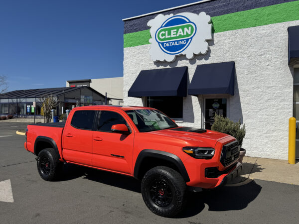 A photo of a bright orange pickup truck that received ceramic coating at Clean Car Wash and Detail in Fredericksburg, VA.